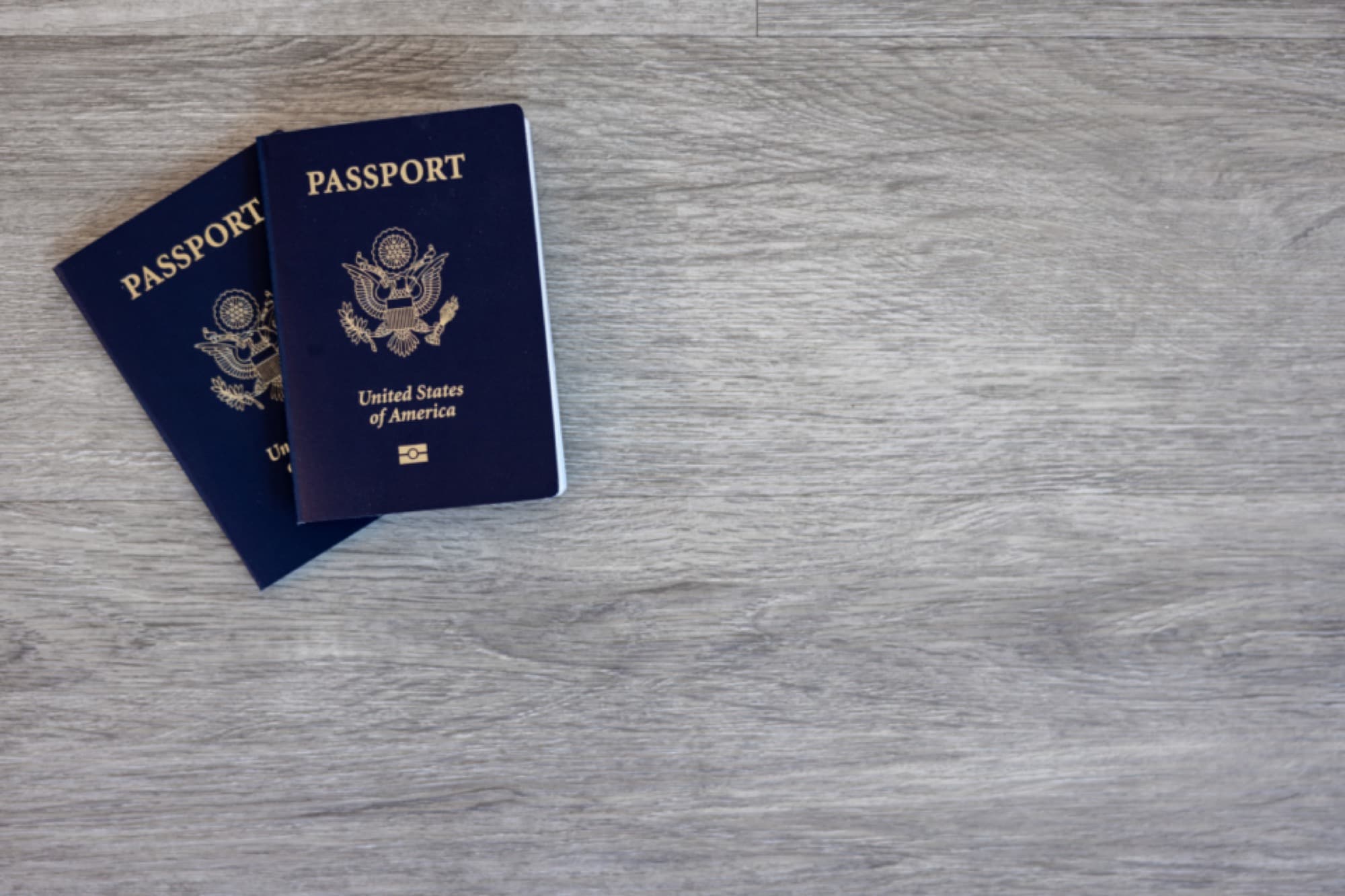 Passport, itinerary printouts and boarding passes laid out on a desk
