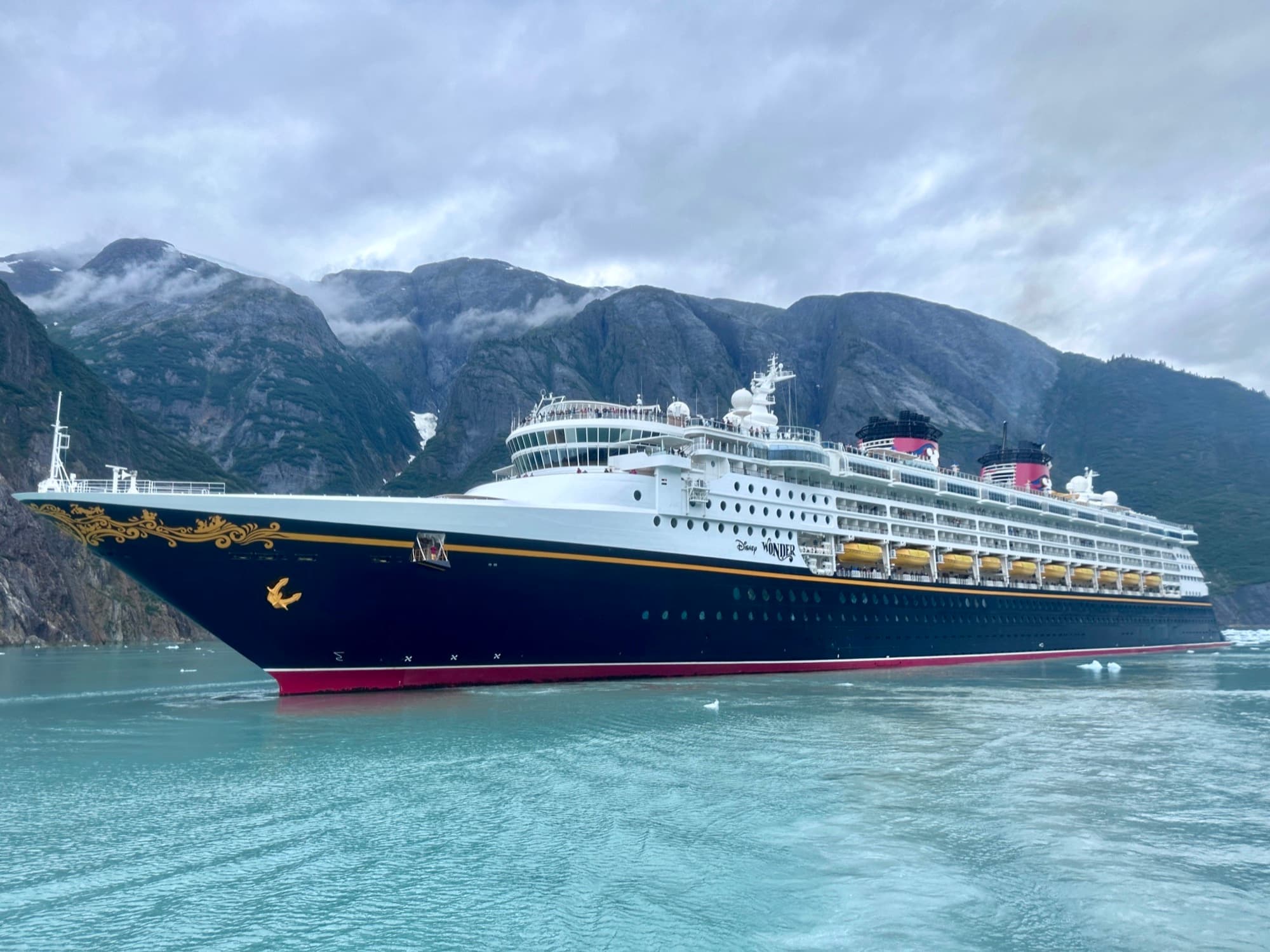 Disney ship in Alaska's Inside Passage, mountains on both sides