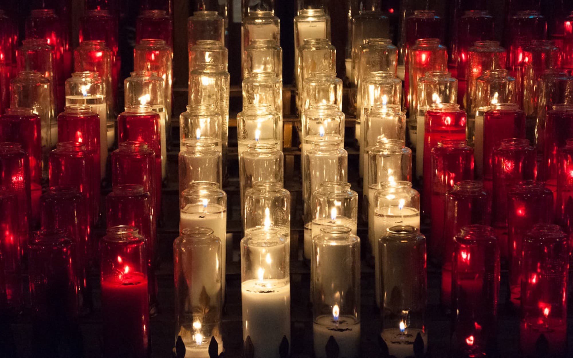 Candles being lit in a quiet European basilica