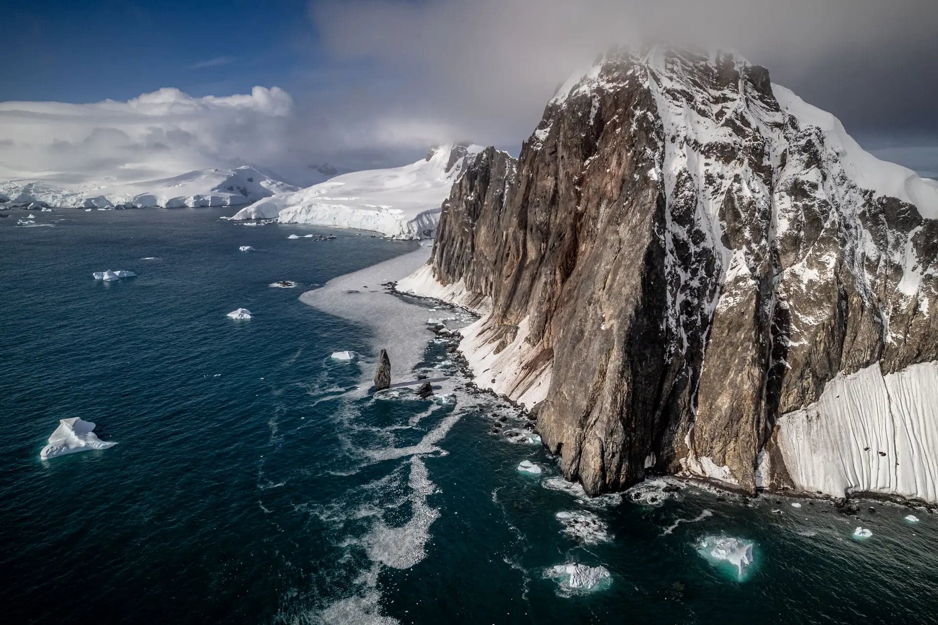 Snow-hung sea cliffs towering over the Peninsula shore